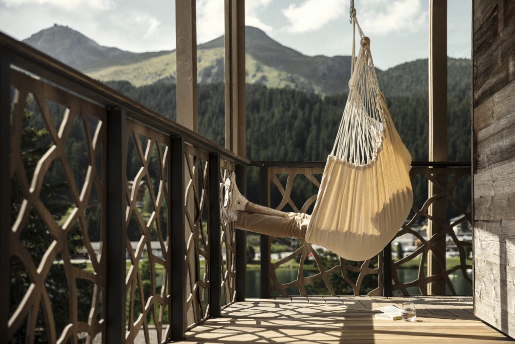 Person sitting on a seat hammock at the Valsana Hotel as advertised by Kiwano Hotels